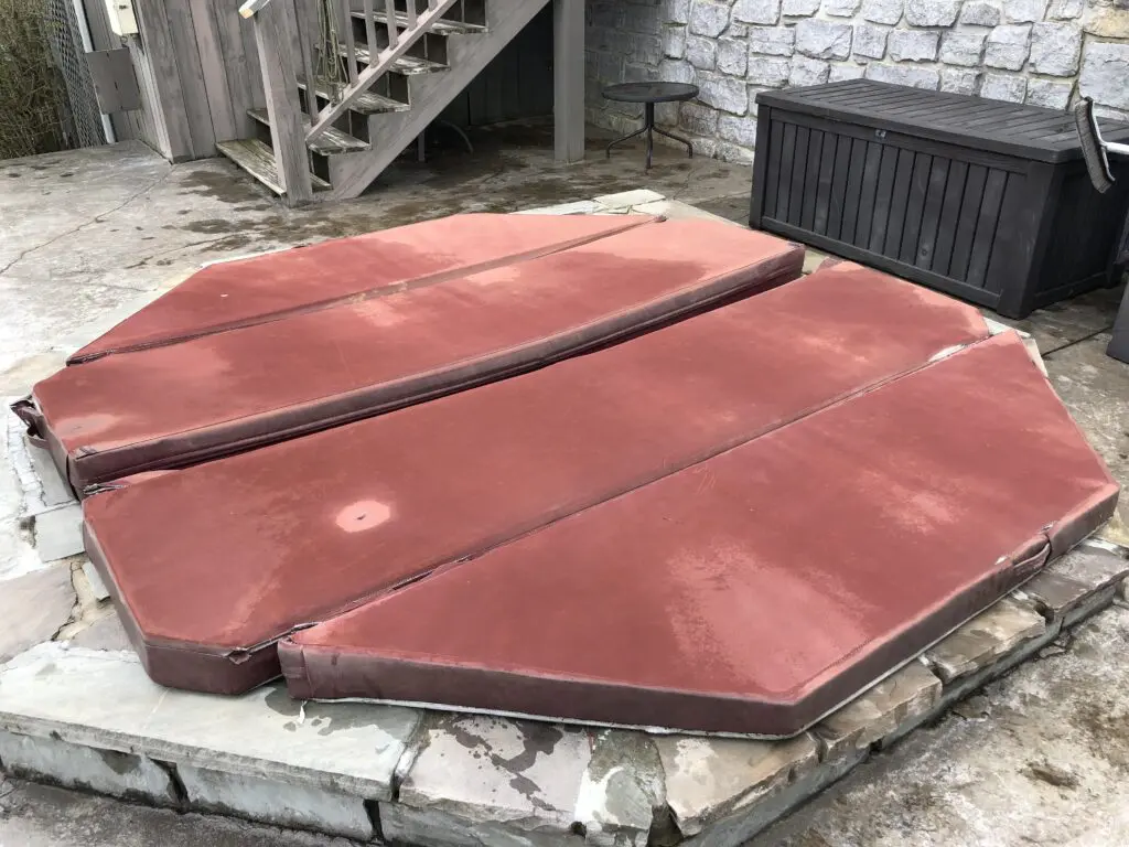 Weathered red octagonal spa cover before replacement